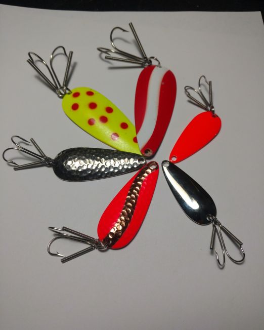A group of six different colored fishing lures.