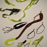 A close up of various fishing lures on a table.