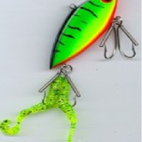 A green and yellow fishing lure hanging on the wall.