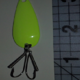 A green fishing lure with two hooks attached to it.