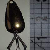 A metal spoon with two small hooks attached to it.