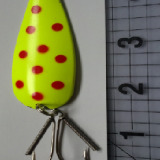 A yellow and red spotted fishing lure with hooks.
