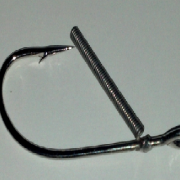 A fishing hook with a long metal handle.