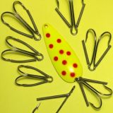 A yellow fishing lure with red dots on it.