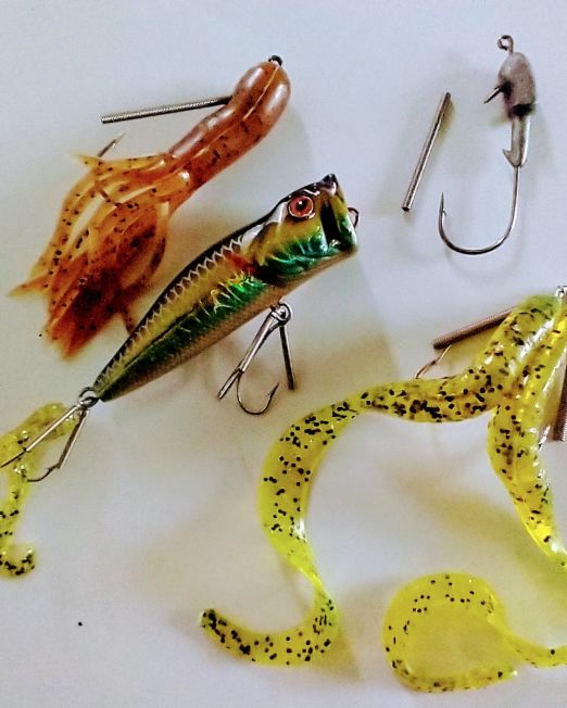 A table with fishing lures and hooks on it.