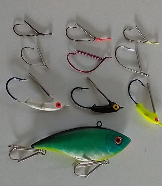 A group of fishing hooks and a fish.